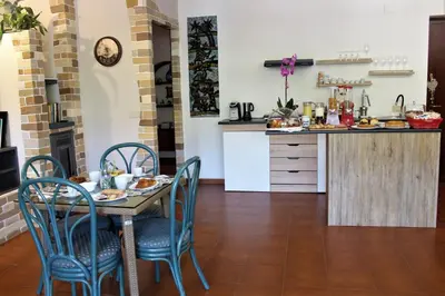 a kitchen and dining room with a table and chairs at B&B Atlante in Palermo
