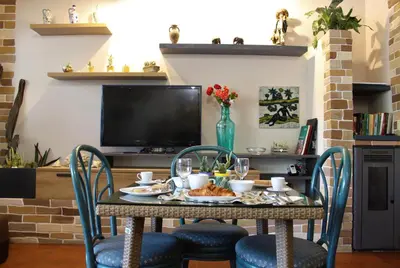 a table with food and drinks on it in a living room at B&B Atlante in Palermo
