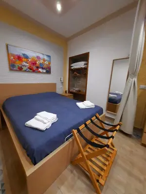 a bedroom with a blue bed with towels on it at Il Sole della Guilla in Palermo