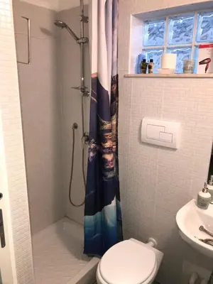 a bathroom with a shower and a toilet and a sink at Casa Nicolina in Palermo
