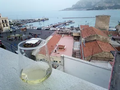 a glass of wine sitting on top of a ledge at Casa Nicolina in Palermo