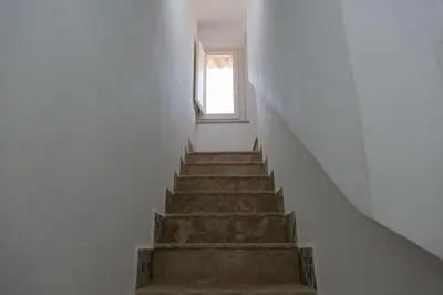 a stairway with a window in a white building at Sopra i tetti di Ballarò in Palermo