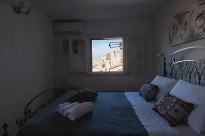 a bedroom with a bed with two towels on it at Sopra i tetti di Ballarò in Palermo