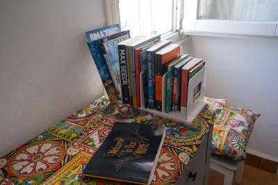 a pile of books sitting on top of a table at Sopra i tetti di Ballarò in Palermo