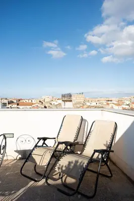 a couple of chairs sitting on a roof at Sopra i tetti di Ballarò in Palermo