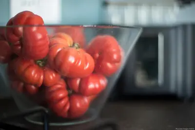 a glass bowl filled with tomatoes on a table at Casa Martini Mondello in Palermo