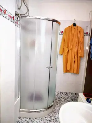a shower in a bathroom with a robe on a wall at Charming Villa in Monreale with Private Pool in Pioppo