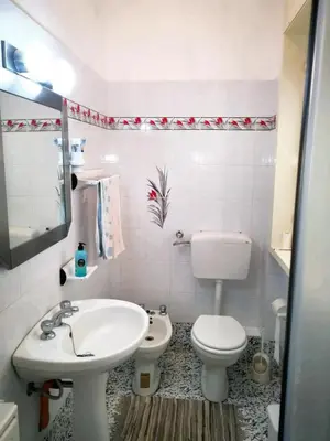 a bathroom with a white toilet and a sink at Charming Villa in Monreale with Private Pool in Pioppo
