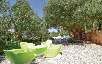 a group of green chairs sitting in a yard at Lovely Home In Makari-S Vito Lo Capo in Macari