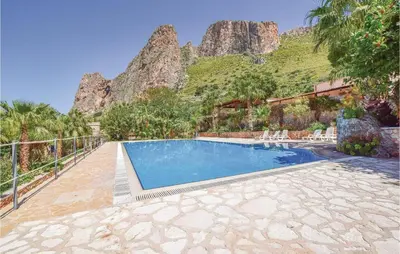 a swimming pool with a mountain in the background at Lovely Home In Makari-S Vito Lo Capo in Macari