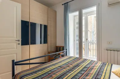 a bedroom with a bed and a large window at Una Finestra sul Teatro Massimo by Wonderful Italy in Palermo