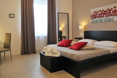 a bedroom with a bed with a blue wall at Location10 in Palermo