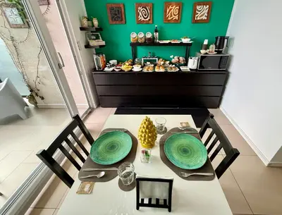 a room with a green wall and a table with food at Location10 in Palermo