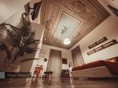 a living room with a couch and a ceiling at CITRUS LUXURY APARTMENT - holiday apartment with up to 3 bedrooms in palermo center in Palermo