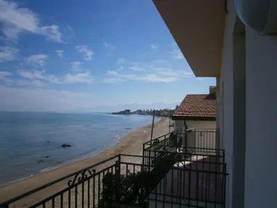 a view of the beach from a balcony of a building at Terrazza sul mare in Trabia