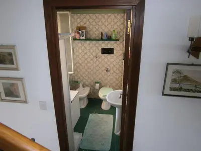 a small bathroom with two toilets and a sink at Terrazza sul mare in Trabia