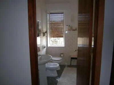 a bathroom with two toilets and a sink and a window at Terrazza sul mare in Trabia