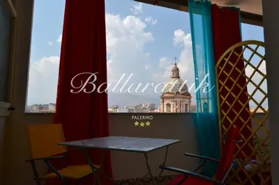 a table and chairs on a window sill with fruit on it at B&b Ballarattik in Palermo