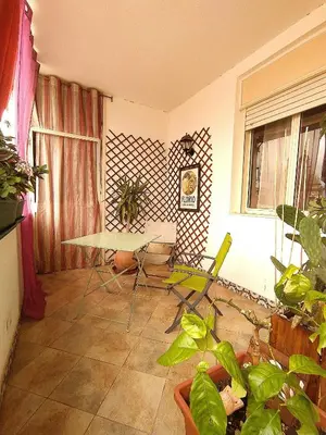 a living room with a table and chairs and plants at B&b Ballarattik in Palermo