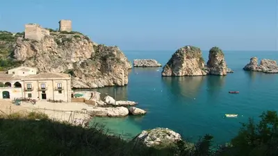 a building in the middle of a body of water at Giardini Del Golfo in Balestrate