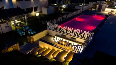 an overhead view of a swimming pool at night at Giardini Del Golfo in Balestrate