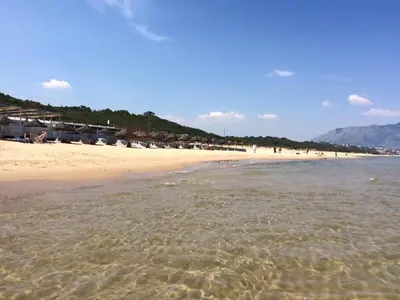 a beach with a group of people in the water at Giardini Del Golfo in Balestrate