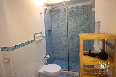a bathroom with a shower with a toilet and a sink at Federico Secondo in Palermo