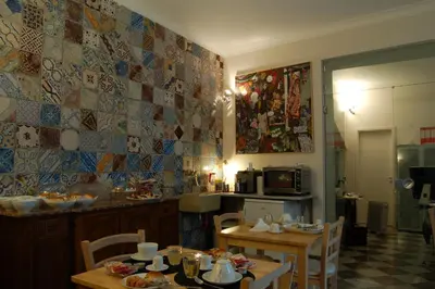 a kitchen with a table and chairs and a kitchen with a table and a kitchen at Federico Secondo in Palermo