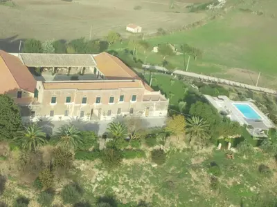 an aerial view of a large house with a pool at Masseria Acque Di Palermo in Roccapalumba