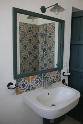 a bathroom with a sink and a mirror at Masseria Acque Di Palermo in Roccapalumba