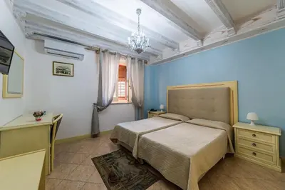 a bedroom with a large bed and a window at Hotel Centrale Bagheria in Bagheria