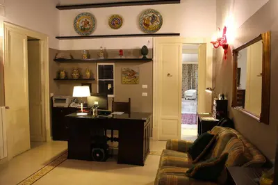 a living room with a couch and a desk in it at Abatellis Luxury in Palermo