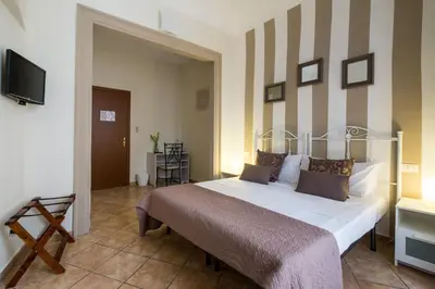 a bedroom with a bed and a flat screen tv at B&B Addauru in Palermo