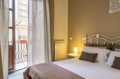 a bedroom with a bed and a large window at B&B Addauru in Palermo