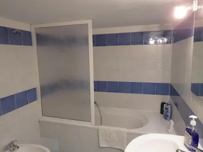 a bathroom with a tub and a sink and a shower at Sunny loft with terrace and Jacuzzi in the city centre in Palermo