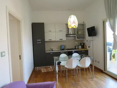 a kitchen with a table and chairs in a room at Sunny loft with terrace and Jacuzzi in the city centre in Palermo
