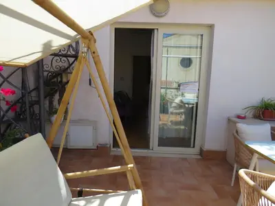 a room with a porch with a sliding glass door at Sunny loft with terrace and Jacuzzi in the city centre in Palermo