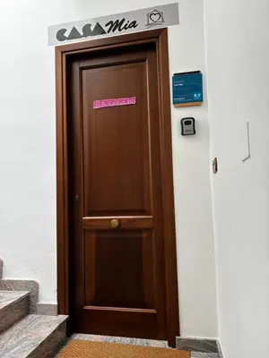 a brown door with a sign on top of it at Casa Mia in Altavilla Milicia