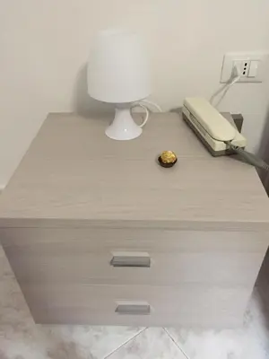 a desk with a phone and a lamp on it at Casa Mia in Altavilla Milicia
