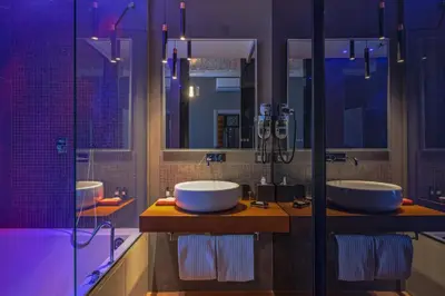 a bathroom with two sinks and a shower at Palco Rooms&Suites in Palermo