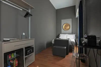 a small room with a bed and a television at Palco Rooms&Suites in Palermo