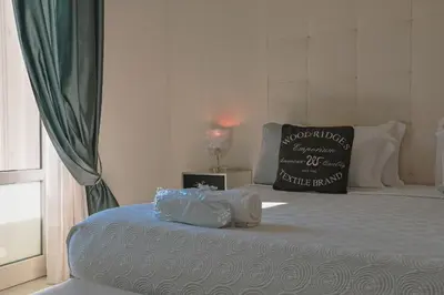 a bed with two plastic bags on it with a pillow at Palco Rooms&Suites in Palermo