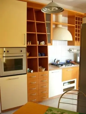 a kitchen with a white refrigerator and a stove at Costapicca in Alcamo