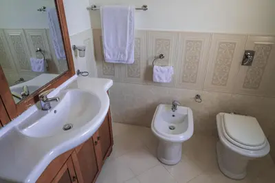 a bathroom with a sink and a toilet at Piano del Re rooms in Partinico