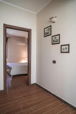 a room with a bedroom with a bed and a mirror at Piano del Re rooms in Partinico