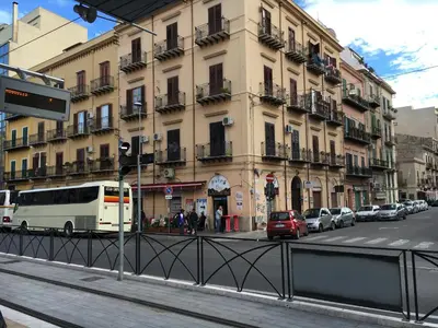 a building on a city street with cars parked in front at White in Palermo