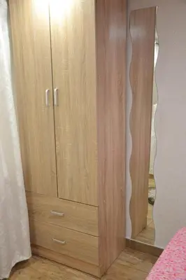 a wooden cabinet with a mirror in a room at Casa Del Vicolo Apartament in Palermo