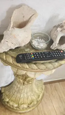 a remote control sitting on top of a glass table at Casa Del Vicolo Apartament in Palermo