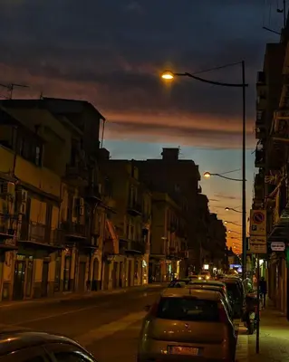 a city street with cars parked on the street at Casa Del Vicolo Apartament in Palermo
