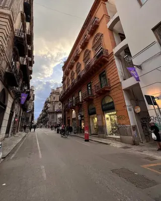 an empty street in a city with buildings at Casa Del Vicolo Apartament in Palermo